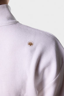 Paggo logo detail on the white Artemis Zip-Up Sweater