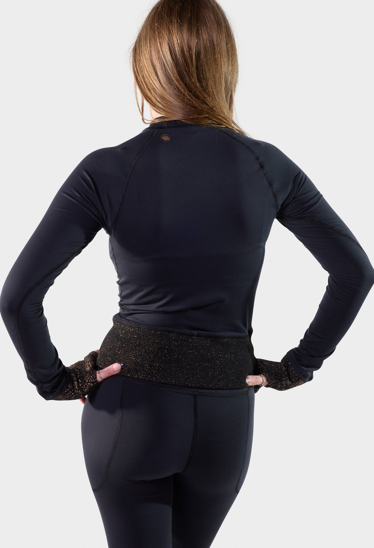 Back view of the black Paggo Athena Top with Lurex waistband and cuffs