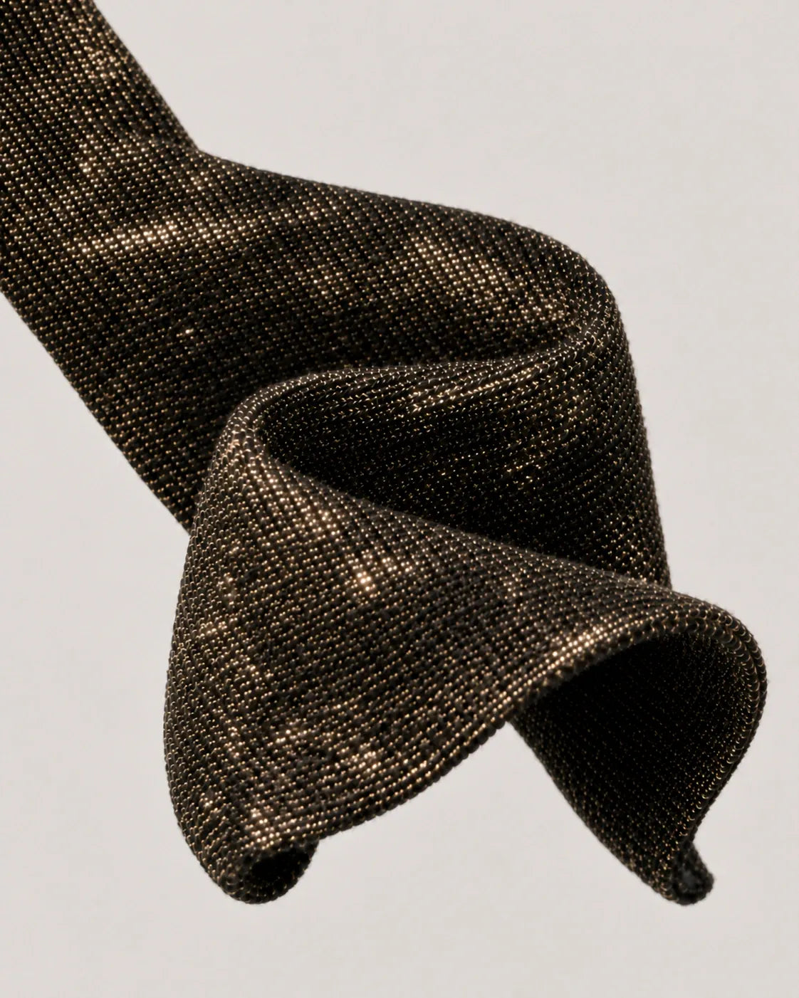 Sculptural study of Paggo black and gold Lurex knit