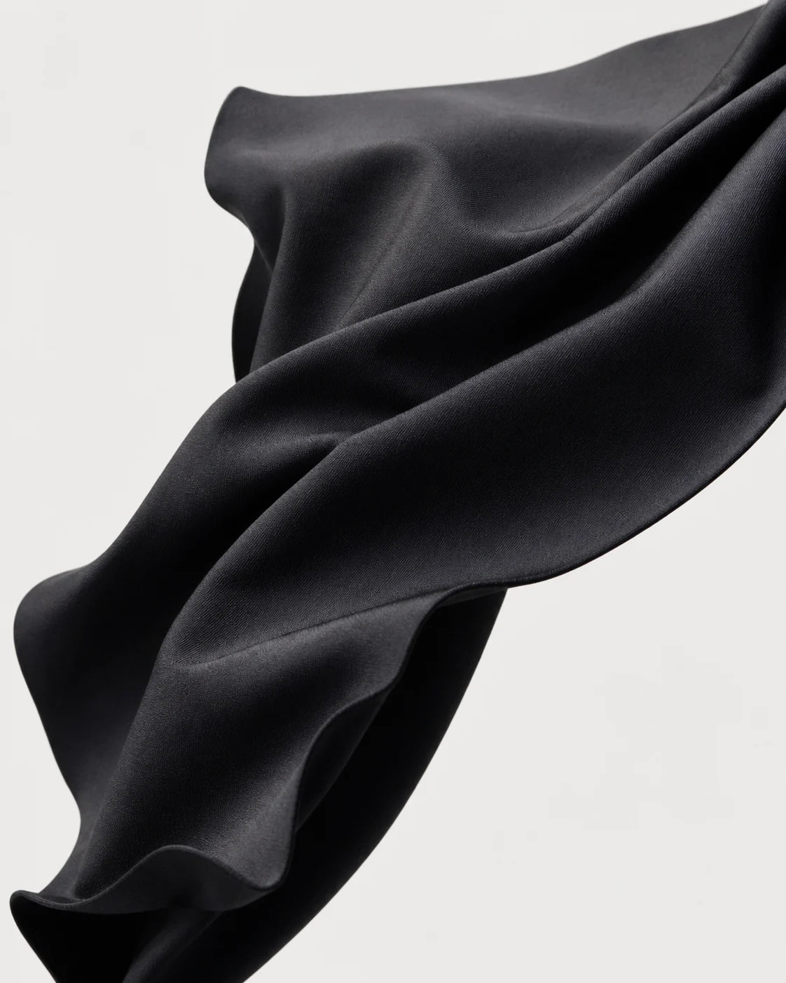 Sculptural study of Paggo matte black performance jersey